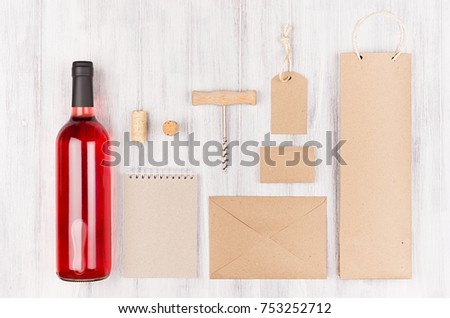 Corporate identity template for wine industry blank beige craft packaging, stationery, merchandise set with bottle rose wine on soft white wood background. 