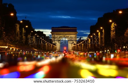 Evening rush-hour on Champs Elysee with the view of illuminated Arc de Triomphe in Paris, France Royalty-Free Stock Photo #753263410