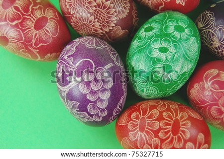 Traditional scratched hand-made Easter egg from Poland on green background