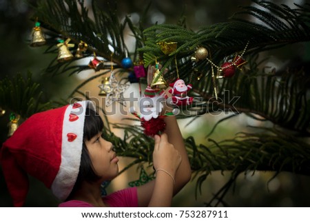 Beautiful  girl decorates the Christmas tree