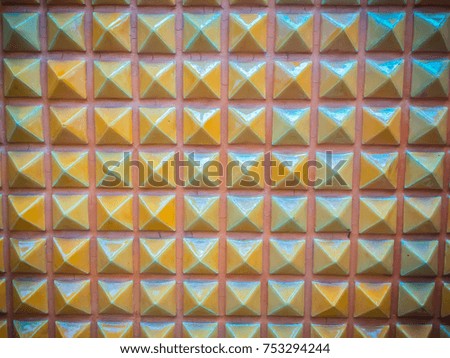 Abstract ceramic wall tiles in the shape of pyramid background. Geometric pattern of pyramid shapes.