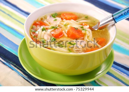 bowl of clear chicken soup with noodle and vegetables Royalty-Free Stock Photo #75329944