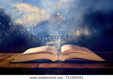 image of open antique book on wooden table with glitter overlay Royalty-Free Stock Photo #753306961