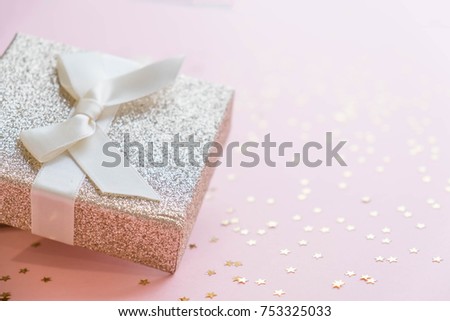 Gold gift box and a small Bell tied a red bo lay on the wood White and pine Christmas day