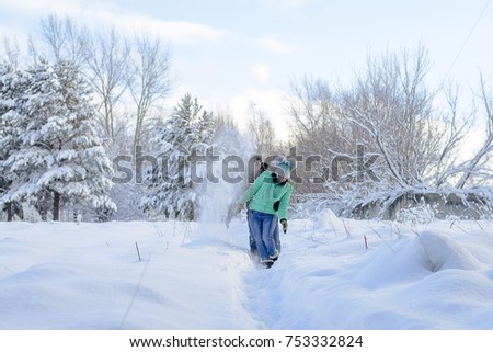 a young couple walk in winter Park, a guy and a girl play in the snow in the Park