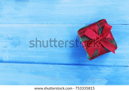 Red green gift box on blue pastel color wooden backgrounds for christmas holiday concept