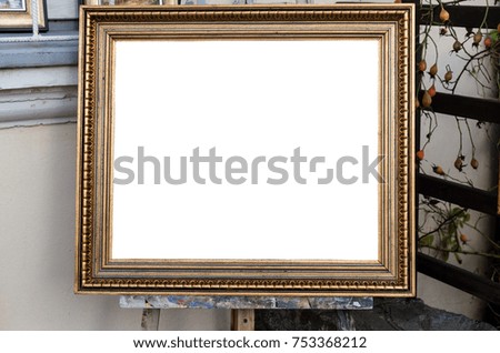 Ornate blank frame on the Easel in outside Art Gallery, White Isolated Clipping Path