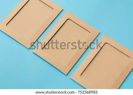 Kraft photo frames on a blue background, cardboard frames