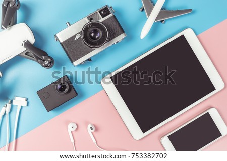 Travel Photographer gadgets and accessories object flat lay Top view on blue and pink background for travel concept with Blank Tablet and Mobile phone screen for Application mock up  Royalty-Free Stock Photo #753382702