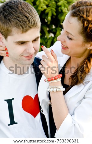 Young loving couple hugging outdoors in the park.