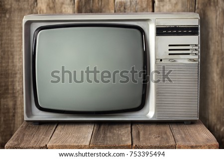 Old vintage TV on wooden table. Retro television 1990s.