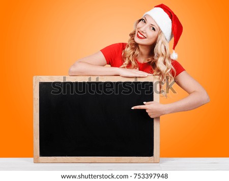 Smiling new year woman showing the index finger  with copy space for product or text