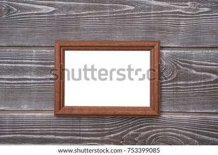 Frame isolated white chalkboard on wooden background. Mock up.