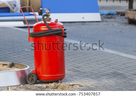 large red industrial fire extinguisher