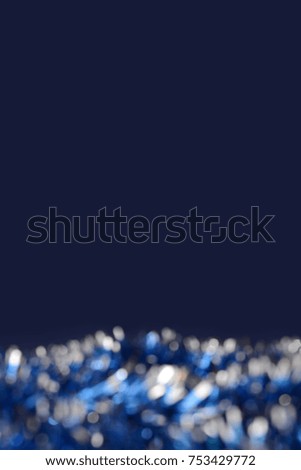 Festive blue and silver Christmas tinsel background. Template backdrop for design.