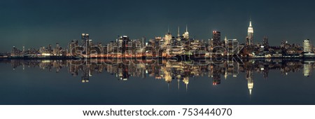 Midtown Manhattan skyline at dusk panorama over Hudson River with reflections