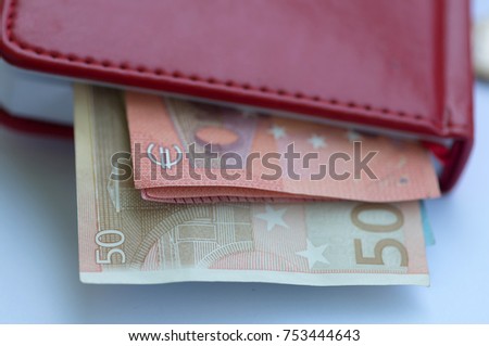 Fifty euros. Fifty euros. Fifty euros invested in a red notebook.  Евро в блокноте. 