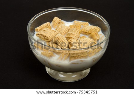 Bowl of Cereal with Milk on a Black Background