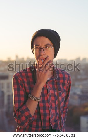 Smoking guy with sunset on background 