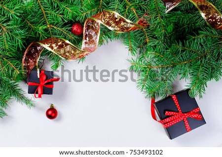Black and red Christmas background. black gift box,  balls, fir branches,red Christmas decorations on the white background  copy space