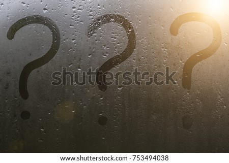 Question marks on the sweaty glass in the autumn