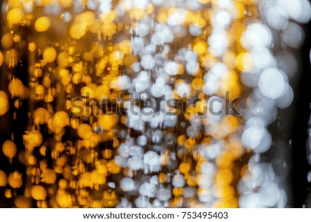 Abstract bright white,yellow and golden Lights blurred bokeh background,blurry lights,glitter sparkle from christmas lights night party with copy space for design content christmas and happy new year