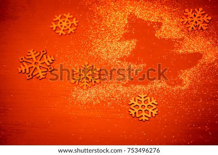 Christmas orange background with  spangles Christmas Tree  and snowfkakes