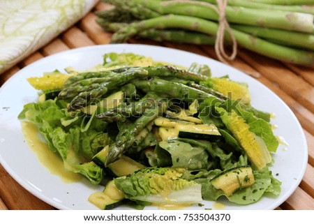 An arrangement of a delicious green asparagus salad. 