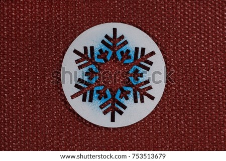 Background picture - symbolic snowflake on a terracotta texture background.