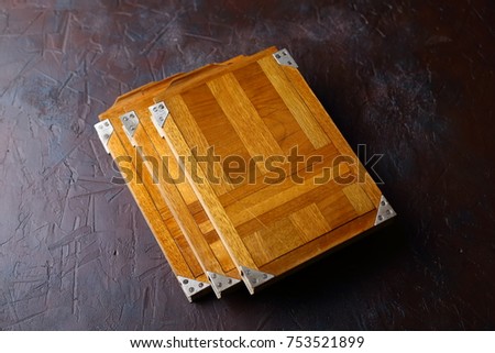 Wooden photocassettes for a large-size vintage camera on a concrete background.