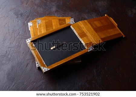Wooden photocassettes for a large-size vintage camera on a concrete background.