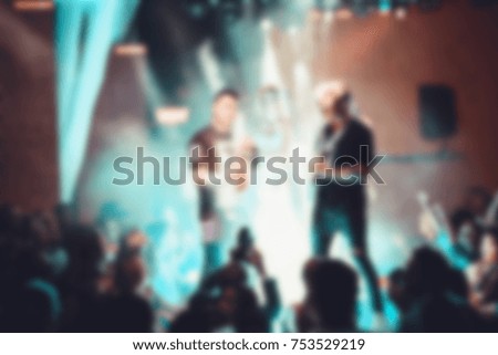 Blurred for background. Night club dj party people enjoy of music dancing sound with colorful light, smoke machine, lights show and dance show. Hands up in earth