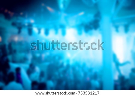Blurred for background. Night club dj party people enjoy of music dancing sound with colorful light with Smoke Machine and lights show. Hands up in earth