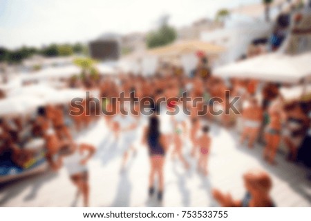 Blurred for background. afternoon dance show during beach party in luxury complex. Young men, women and children participating in Resources Dance show during party under sun