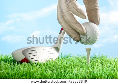 Series of golfing equipment concept pictures.
Shot in studio on grass with blue background: Teeing the Ball