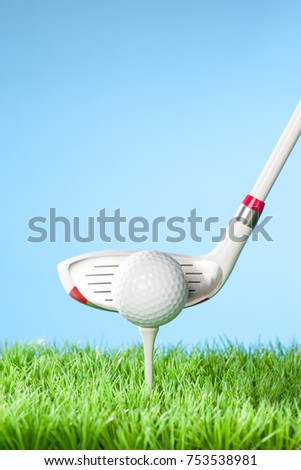 Hybrid driver about to Hit the Ball, Series of golfing equipment concept pictures.
Shot in studio on grass with blue background