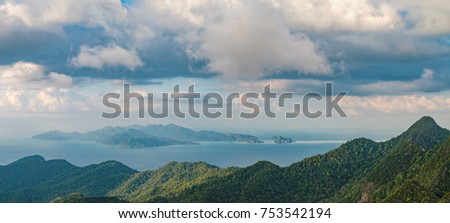 Panoramic view of blue sky, sea and mountain seen from Cable Car viewpoint, Langkawi, Malaysia. Picturesque landscape with tropical forest, beaches, small Islands in waters of Strait of Malacca