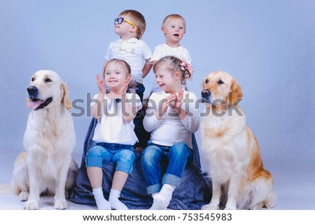 Children with Down Syndrome. Friendly company and dogs. Canistherapy. Down syndrome. Denis and dogs. Special assistance. Teaching children with disabilities. Autism Royalty-Free Stock Photo #753545983