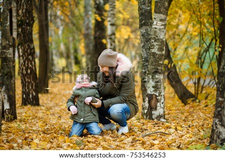 Happy family mother and child daughter on autumn walk