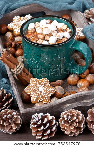 Mug with hot chocolate  and gingerbread cookies on wooden table