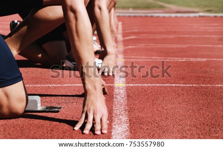 Cropped image of a sprinter getting ready to start at the stadium Royalty-Free Stock Photo #753557980