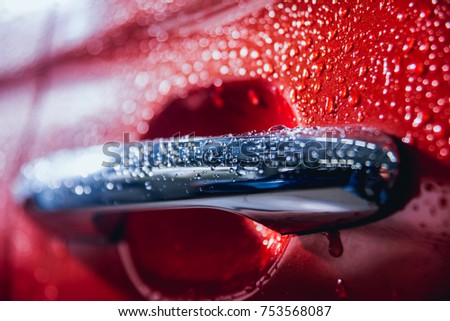 Details of electric car. Door handle and rain drops. Red color Royalty-Free Stock Photo #753568087
