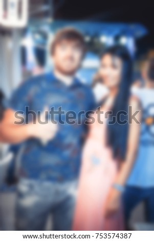 Blurred for background. club party. People smiling and posing on cam during concert in night club party. Man and woman have fun at club. Boy and girl at night club party