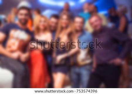 Blurred for background. club party. People smiling and posing on cam during concert in night club party. Man and woman have fun at club. Boy and girl at night club party