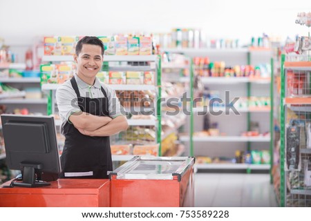 Portrait of a smiling shopkeeper in a grocery store Royalty-Free Stock Photo #753589228