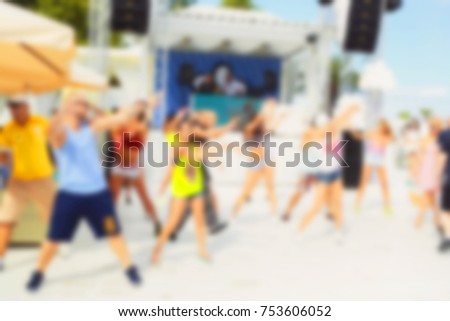 Blurred for background. afternoon dance show during beach party in luxury complex. Young men, women and children participating in Resources Dance show during party under scorching sun.