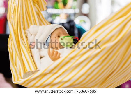 picture of a newborn doll in a hammock