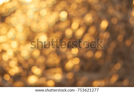 Golden Christmas background with natural bokeh and twinkled defocused lights. Festive blur background