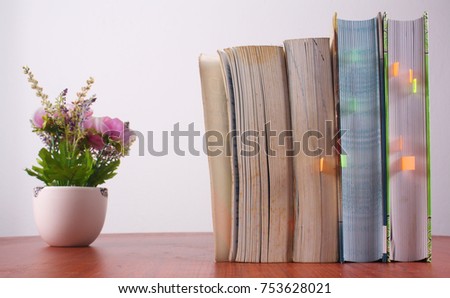 Photo for books on the table with grey wall as a background. 