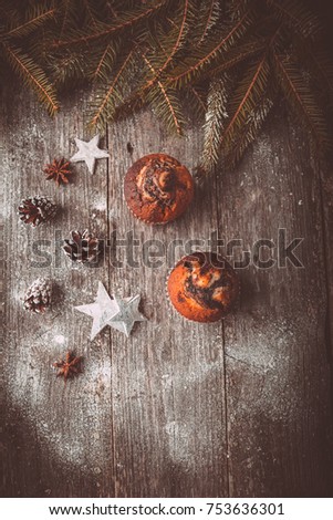 Xmas composition with holiday decoration - Homemade christmas cupcakes on wooden background with spruce twigs and pinecones. Christmas card. Space for text, Vintage style. Toned picture by Instagram